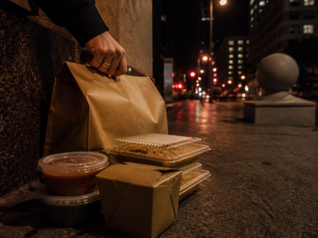Takeout bags on a downtown Toledo sidewalk at night